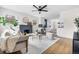 Bright, airy living room with hardwood floors, fireplace, and seamless flow into the kitchen at 1445 Ash St, Denver, CO 80220