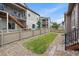 A well-maintained backyard with manicured lawn, pea gravel and wood fencing is shown at 3336 Goodyear St, Castle Rock, CO 80109