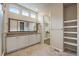 Bright primary bath featuring double sinks, a walk-in closet, and updated fixtures at 3336 Goodyear St, Castle Rock, CO 80109