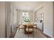 Bright dining room features hardwood floors, large windows and elegant light fixture at 3336 Goodyear St, Castle Rock, CO 80109