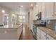 Modern kitchen boasts stainless appliances, granite counters, and ample storage space at 3336 Goodyear St, Castle Rock, CO 80109