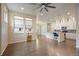 Living room showcasing hardwood floors and open layout flowing into a bright, modern kitchen at 3336 Goodyear St, Castle Rock, CO 80109