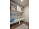 Well-appointed mudroom featuring tiled backsplash, built-in storage, bench, and coat hooks at 3336 Goodyear St, Castle Rock, CO 80109