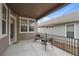 A cozy covered patio features neutral tones, modern railing, and space for outdoor seating at 3336 Goodyear St, Castle Rock, CO 80109