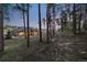 Backyard view of craftsman home nestled among the trees with a walkout patio at 16244 Thunder Cat Way, Monument, CO 80132