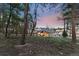 Beautiful backyard view of the home surrounded by a private wooded lot with mature trees and lush foliage at 16244 Thunder Cat Way, Monument, CO 80132