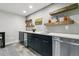 Basement bar with sleek cabinetry, quartz countertops, a beverage fridge, and floating shelves at 16244 Thunder Cat Way, Monument, CO 80132