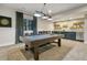 Game room with a pool table, dart board, and a bar area with sleek cabinetry and floating shelves at 16244 Thunder Cat Way, Monument, CO 80132