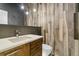 Unique bathroom with wood-look tile wall, modern vanity, and hanging pendant lights, adding warmth and style at 16244 Thunder Cat Way, Monument, CO 80132