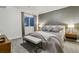 Stylized bedroom with neutral colors, a bench at the end of the bed, and modern decor at 16244 Thunder Cat Way, Monument, CO 80132