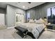Comfortable primary bedroom with modern decor, featuring gray accent wall and barn door to bathroom at 16244 Thunder Cat Way, Monument, CO 80132