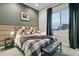 Cozy bedroom featuring a large window, comfortable bed, and stylish decor at 16244 Thunder Cat Way, Monument, CO 80132