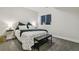 Cozy bedroom showcasing a patterned bedspread, bedside tables with lamps, and a bench at the foot of the bed at 16244 Thunder Cat Way, Monument, CO 80132