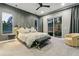 Stylish bedroom featuring a sliding glass door with patio access, gray walls, and a unique headboard design at 16244 Thunder Cat Way, Monument, CO 80132