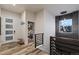 A stylish hallway features wood floors, a modern light fixture, and a view into a bedroom at 16244 Thunder Cat Way, Monument, CO 80132