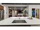 An open-concept layout showcases a kitchen island with sink, with views into the living room and dining areas at 16244 Thunder Cat Way, Monument, CO 80132