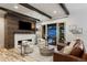 The living room features a modern fireplace, a television, and a sliding glass door to the outdoor space at 16244 Thunder Cat Way, Monument, CO 80132