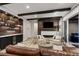 Cozy living room with stylish wood accents, fireplace, and a well-stocked bar area with drink cooler at 16244 Thunder Cat Way, Monument, CO 80132