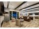 Spacious living room open to the kitchen, featuring hardwood floors, beam ceilings, and a fireplace at 16244 Thunder Cat Way, Monument, CO 80132