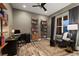 Modern home office with natural light, custom shelves, and sophisticated décor at 16244 Thunder Cat Way, Monument, CO 80132