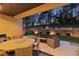 Outdoor patio with a seating area, gas grill, and fire pit overlooking the backyard at 16244 Thunder Cat Way, Monument, CO 80132