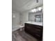 Modern bathroom featuring a shower-tub combo and vanity with dark wood cabinets at 9220 Wilde Ln # 102, Parker, CO 80134