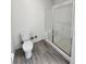 Modern bathroom with walk-in shower, toilet, and wood-style flooring at 9220 Wilde Ln # 102, Parker, CO 80134