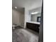 Modern bathroom with a glass shower, large vanity, and updated fixtures throughout at 9220 Wilde Ln # 102, Parker, CO 80134