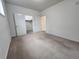 Bright bedroom has a walk-in closet and neutral carpeting at 9220 Wilde Ln # 102, Parker, CO 80134