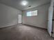 Bright bedroom featuring natural light, carpeted floor, and an exit to the outside at 9220 Wilde Ln # 102, Parker, CO 80134