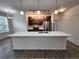 Spacious kitchen boasts a large island, stainless appliances, and modern cabinetry at 9220 Wilde Ln # 102, Parker, CO 80134