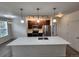 Well-lit kitchen with stainless steel appliances and white countertop island with pendant lights at 9220 Wilde Ln # 102, Parker, CO 80134