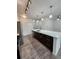 Bright kitchen features a large island with stainless steel appliances and modern pendant lighting at 9220 Wilde Ln # 102, Parker, CO 80134