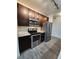 Modern kitchen features stainless steel appliances, sleek countertops, and rich dark cabinetry at 9220 Wilde Ln # 102, Parker, CO 80134