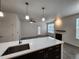 Open living area featuring modern light fixtures, fireplace and stylish flooring at 9220 Wilde Ln # 102, Parker, CO 80134