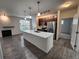 Open concept living room boasts a large island, modern lighting, and lots of space at 9220 Wilde Ln # 102, Parker, CO 80134