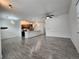 Open-concept living area featuring modern gray flooring and kitchen with stainless appliances at 9220 Wilde Ln # 102, Parker, CO 80134