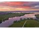 Scenic aerial view of lake at sunset with homes at 3929 S Quemoy Ct, Aurora, CO 80018