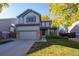 Two-story house with gray siding, attached garage, and landscaped yard at 3929 S Quemoy Ct, Aurora, CO 80018