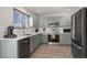 Modern kitchen with gray cabinets, stainless steel appliances, and white countertops at 3929 S Quemoy Ct, Aurora, CO 80018