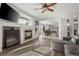 Open concept living room with fireplace, kitchen view, and hardwood floors at 3929 S Quemoy Ct, Aurora, CO 80018