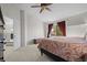 Main bedroom with king bed, window, and ceiling fan at 3929 S Quemoy Ct, Aurora, CO 80018