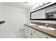 Bathroom featuring double sink vanity, granite countertops, and square decorative mirrors at 2078 Goldfinch Ct, Longmont, CO 80503