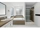 Bathroom featuring tub, shower, and modern fixtures and finishes at 2078 Goldfinch Ct, Longmont, CO 80503