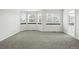 Spacious bedroom featuring neutral tones, large windows, and gray carpet at 2078 Goldfinch Ct, Longmont, CO 80503