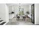 Cozy dining area features a round table, modern chandelier, and a view to outside greenery at 2078 Goldfinch Ct, Longmont, CO 80503
