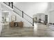 Bright entryway with modern staircase, wood floors, and open layout leading to dining area at 2078 Goldfinch Ct, Longmont, CO 80503