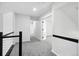 Second floor hallway leading to bedrooms with neutral-toned walls and carpets at 2078 Goldfinch Ct, Longmont, CO 80503