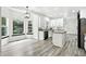 Kitchen with a large window, modern lighting, and beautiful gray-toned flooring at 2078 Goldfinch Ct, Longmont, CO 80503
