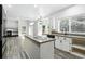 Open kitchen layout features modern island with cooktop and stainless steel appliances at 2078 Goldfinch Ct, Longmont, CO 80503
